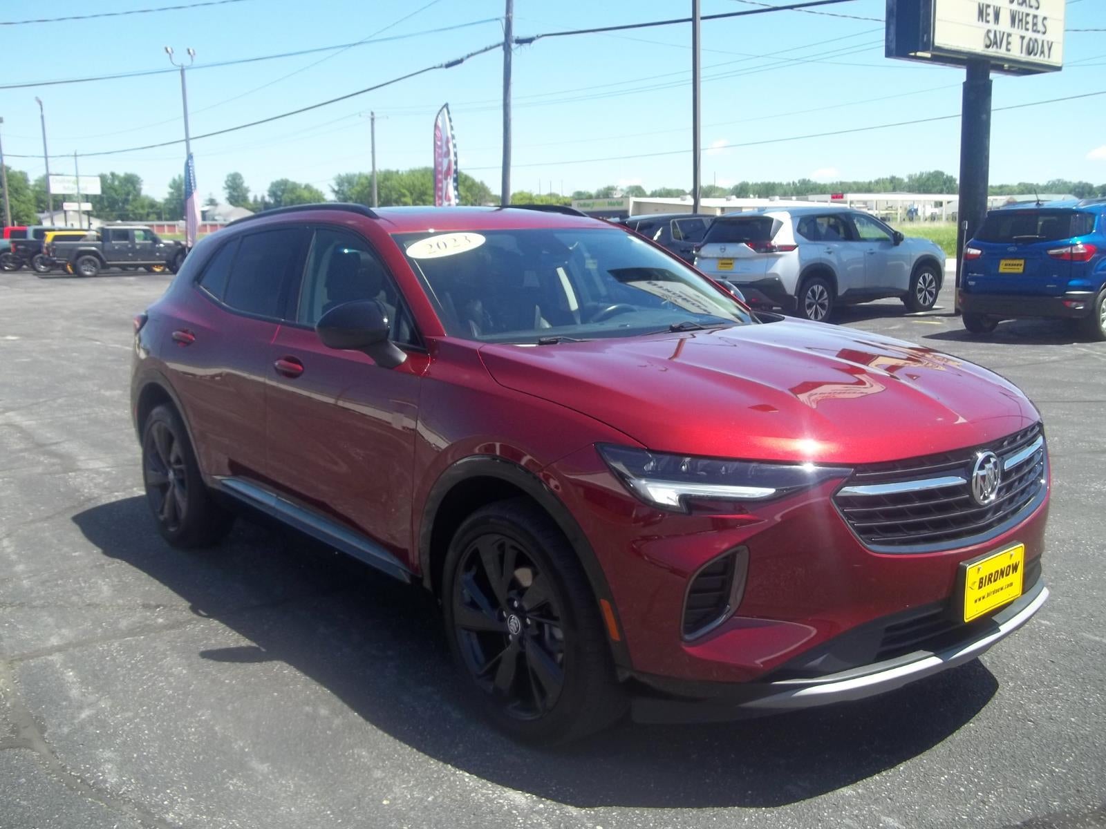 2023 Buick Envision Essence in Cinnabar Metallic — front three-quarter view
